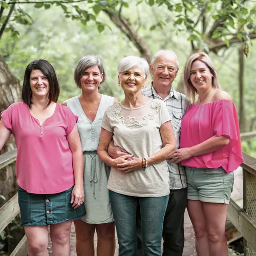 Senior couple with their three daughters on a bridge.  Couple de seniors avec leurs trois filles sur un pont