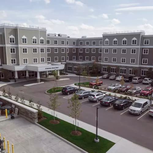 Exterior and parking lot at Chartwell Balmoral Retirement Community.