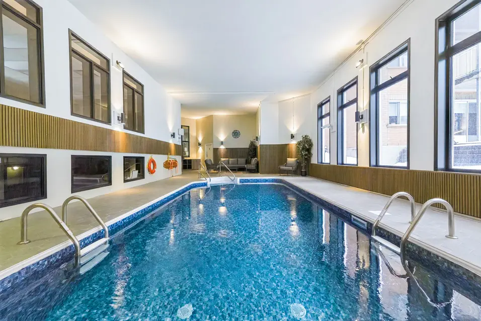 Piscine intérieure lumineuse avec accès sécurisé à Chartwell Manoir et Cours de l'Atrium / Bright indoor swimming pool at Chartwell Manoir et Cours de l'Atrium