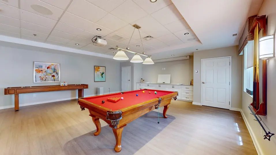 Activity room with pool table at Chartwell Dufferin Centre
