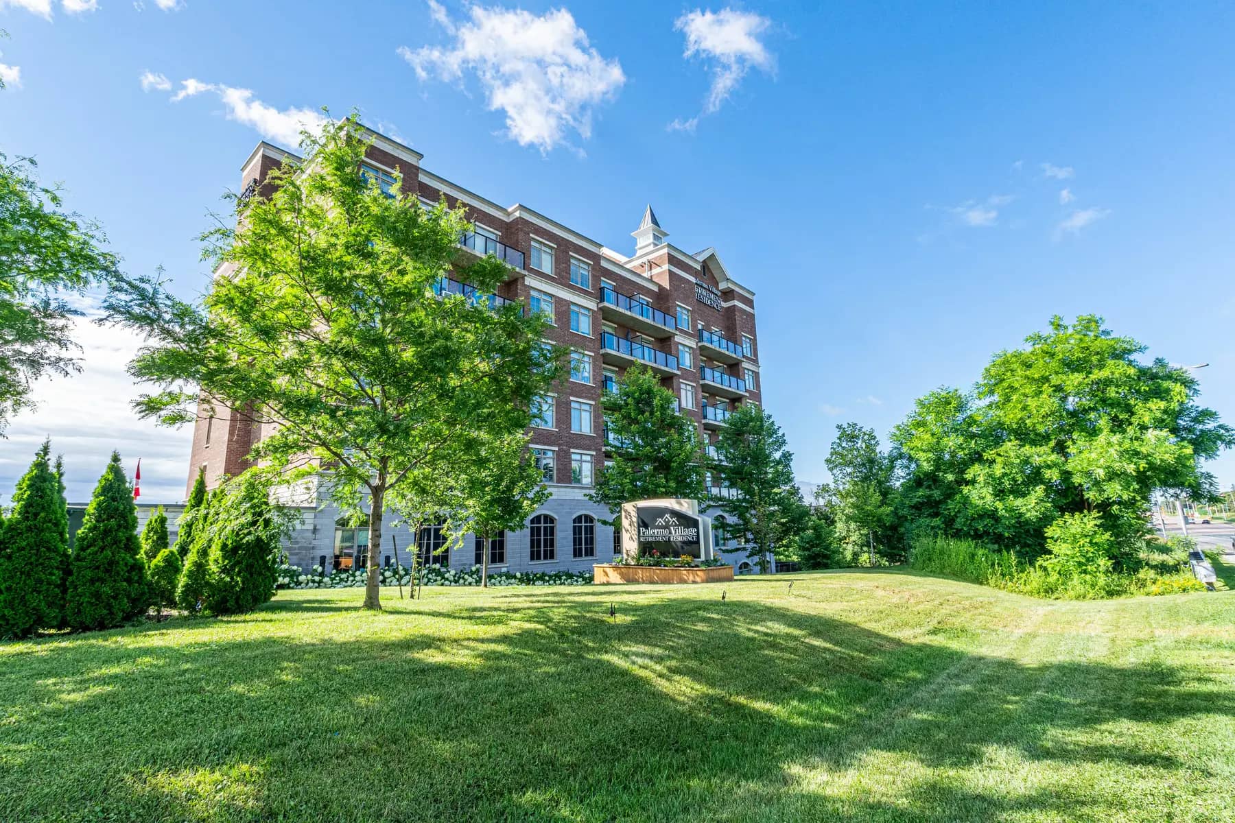 Chartwell Palermo Village Exterior. Exterior shot of the building surrounded by greenery.