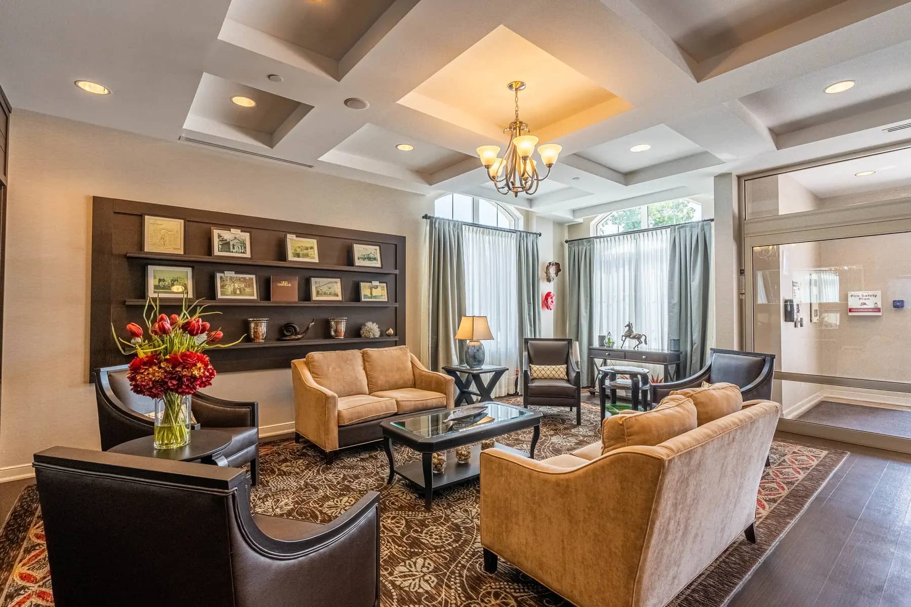 Chartwell Palermo Village lobby. This area is nicely decorated with couches, a leather wing back chair and coffee table.