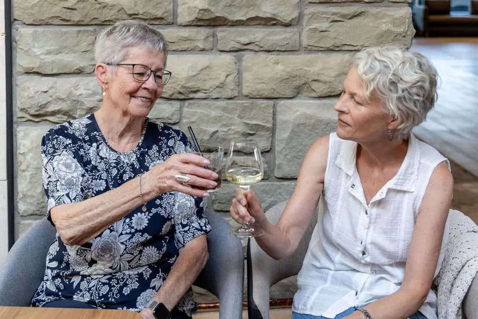 Senior women tossing a glass of wine at Chartwell The Edward / Des femmes âgées buvant un verre de vin à Chartwell L'Édouard