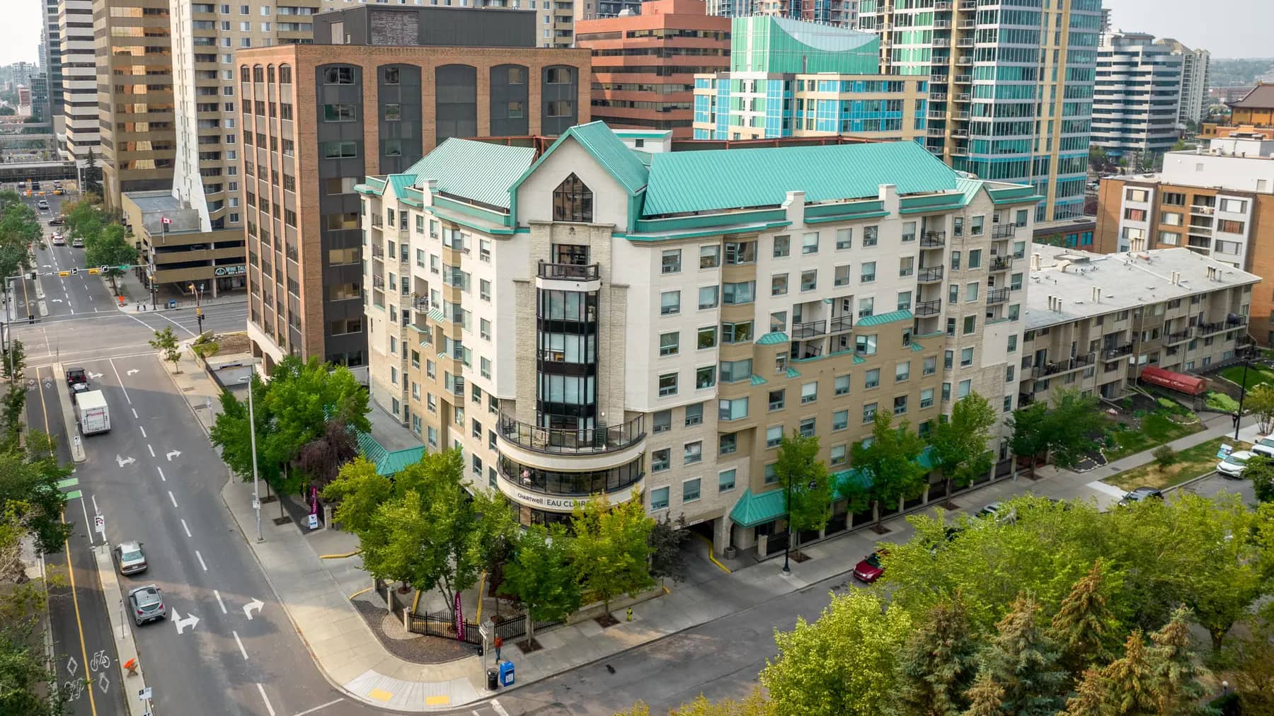wide angle exterior drone picture with views of downtown Calgary at chartwell eau claire care residence