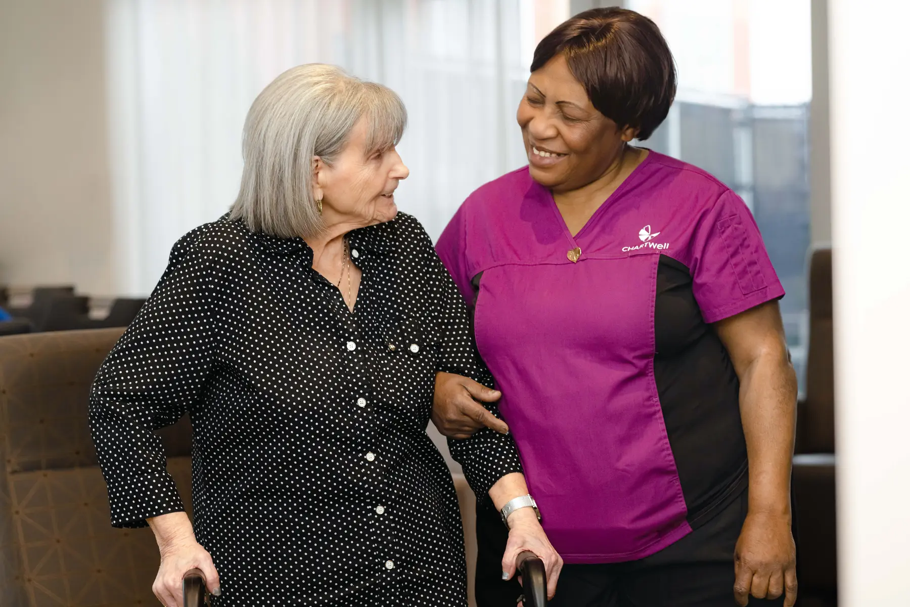 senior woman helped by nurse, personal support worker