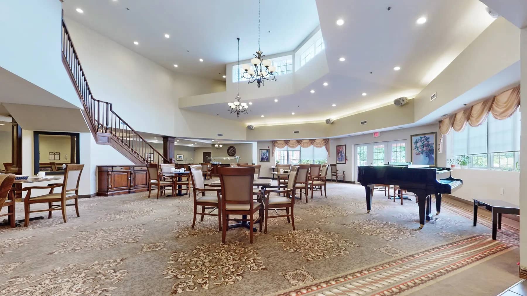 Dining room with table, chairs and piano at Chartwell Franklin Park