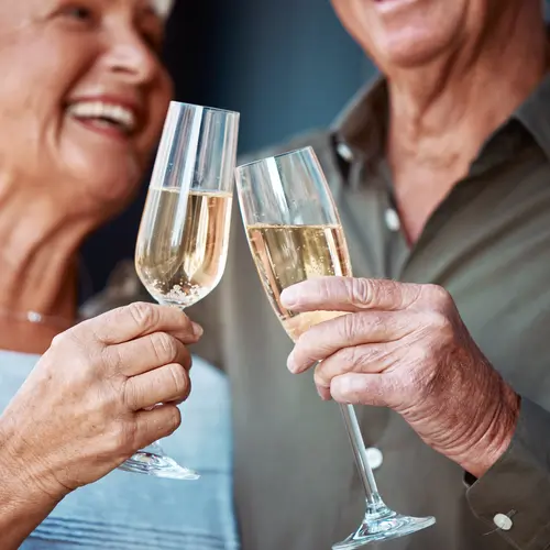 Champagne, love and senior couple toast for marriage anniversary date, partnership or retirement health. Romance, glass alcohol drinks and elderly people smile, bond and cheers at celebration event.