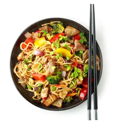 Plate of noodles with meat and vegetables with chopstick