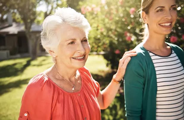 Senior woman with her hand on her daughter's shoulder. Femme âgée posant la main sur l'épaule de sa fille