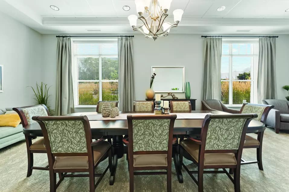 Chartwell Allandale Station Retirement Residence private dining room with comfortable seating and a large dining table.