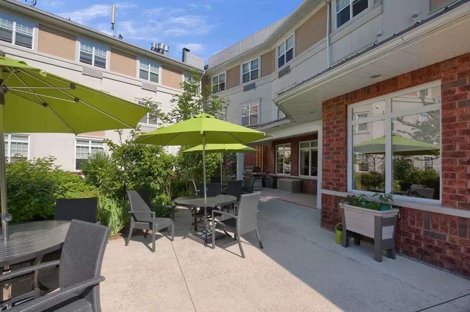 Chartwell Conservatory Pond's exterior patio with tables and umbrellas