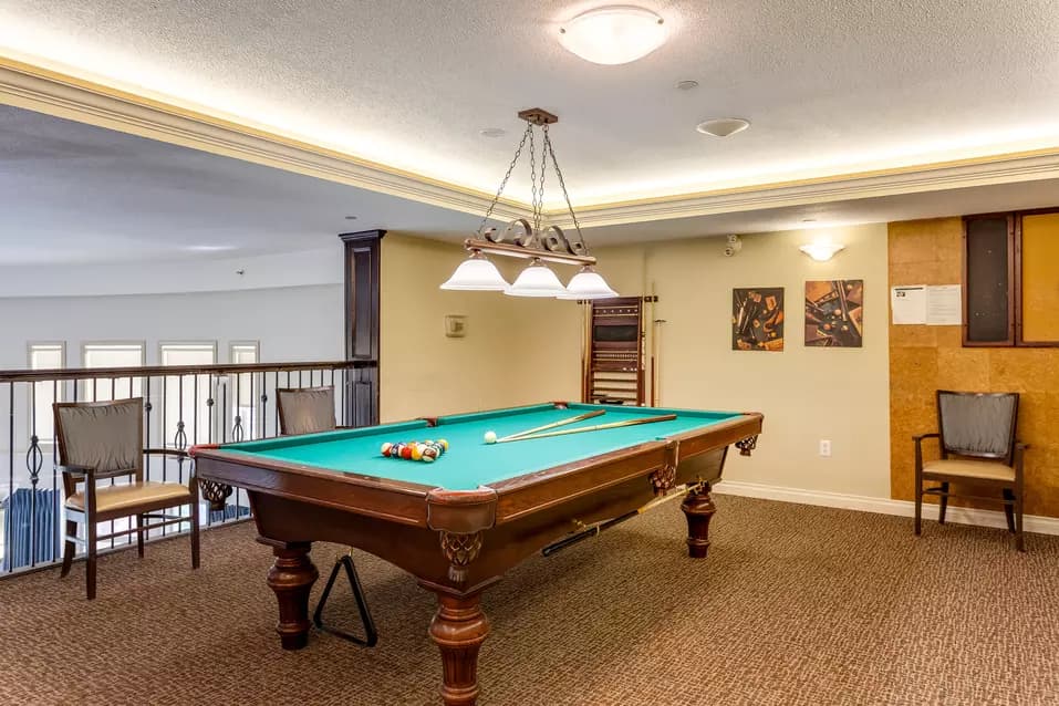 pool table and sitting area at chartwell colonel belcher retirement residence