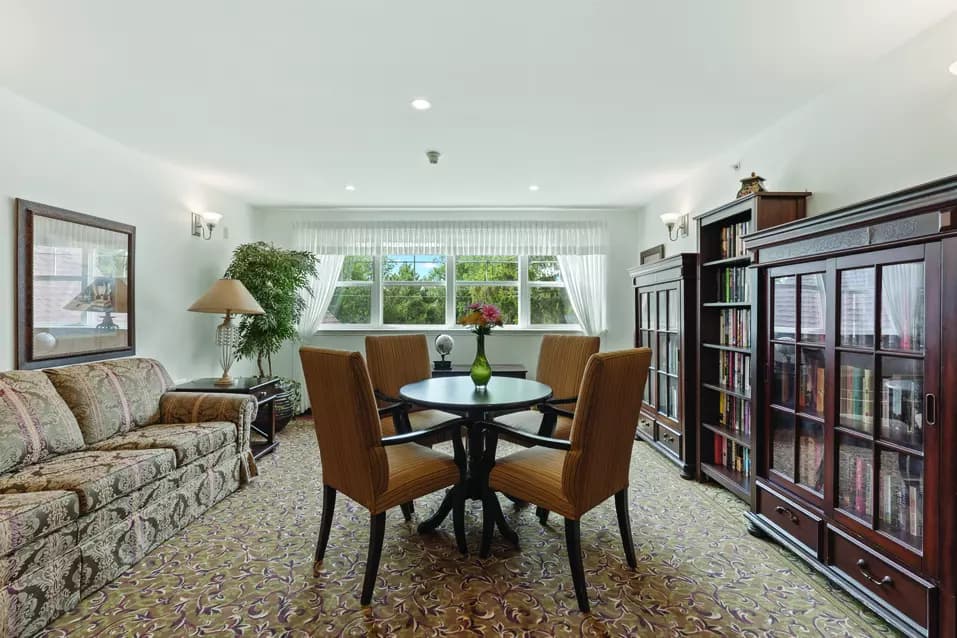 Chartwell Regency Retirement Residence library with tables and seating