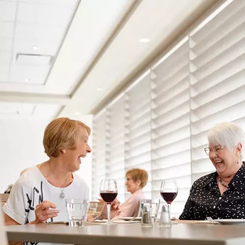 Chartwell senir residents enjoying glass of wine at the dining table