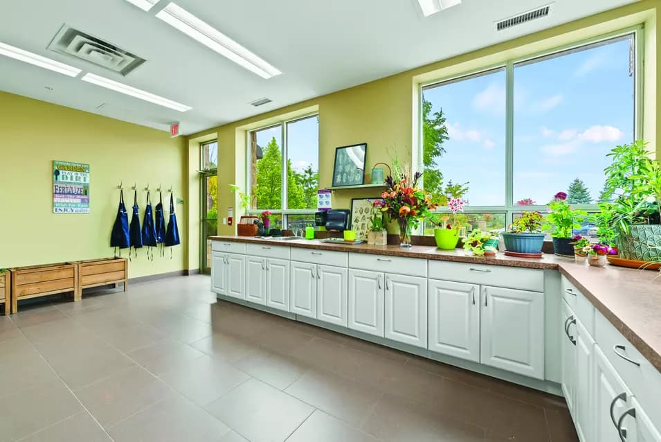 Sunroom with planting stations at Chartwell Hollandview Trail Retirement Residence.